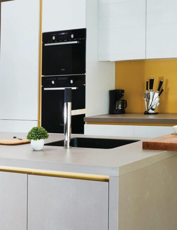 Sleek and modern kitchen interior featuring a large island and open shelving in a contemporary setting.